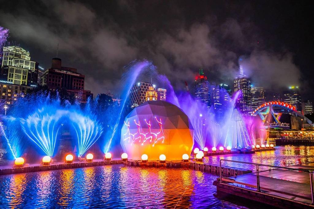 projections on a ball and water fountains in the river at the Christmas River Show