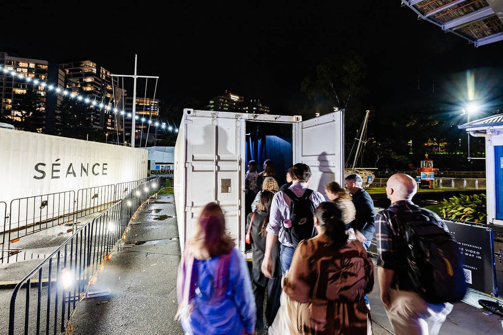 people entering the shipping container for Darkfield Flight, which is coming to Melbourne