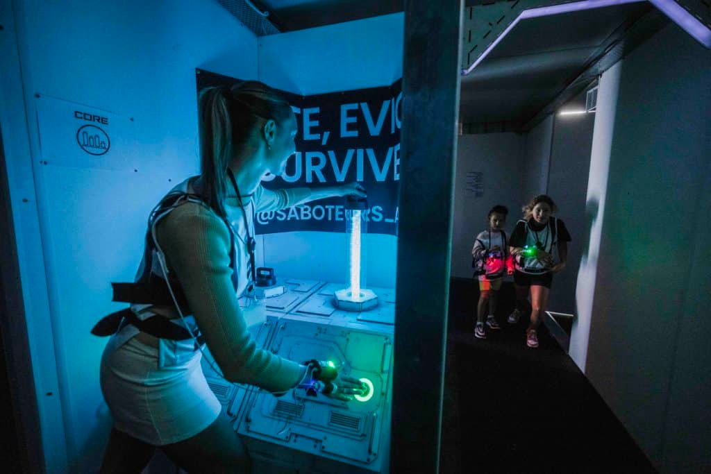 A person plays the Saboteurs immersive game at The District Docklands in Melbourne.