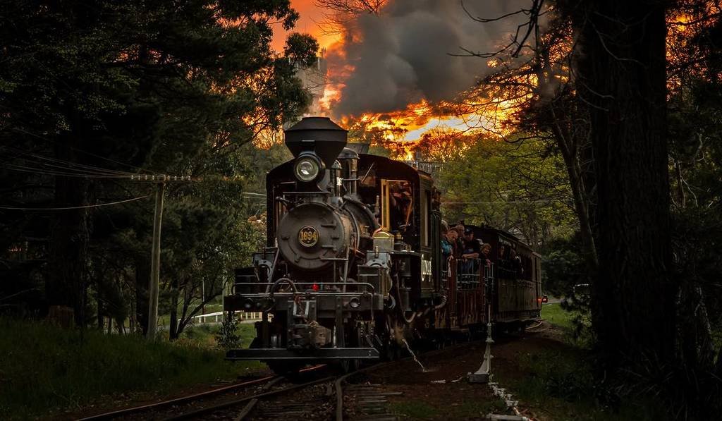 a Puffing Billy train travelling at twilight