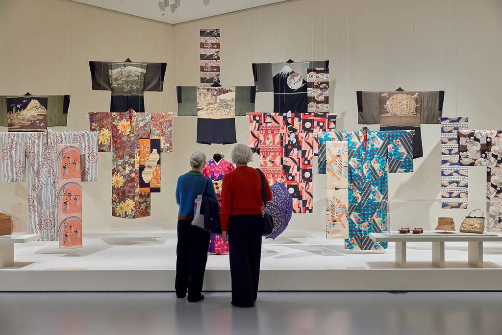 two people looking at kimono on display in NGV