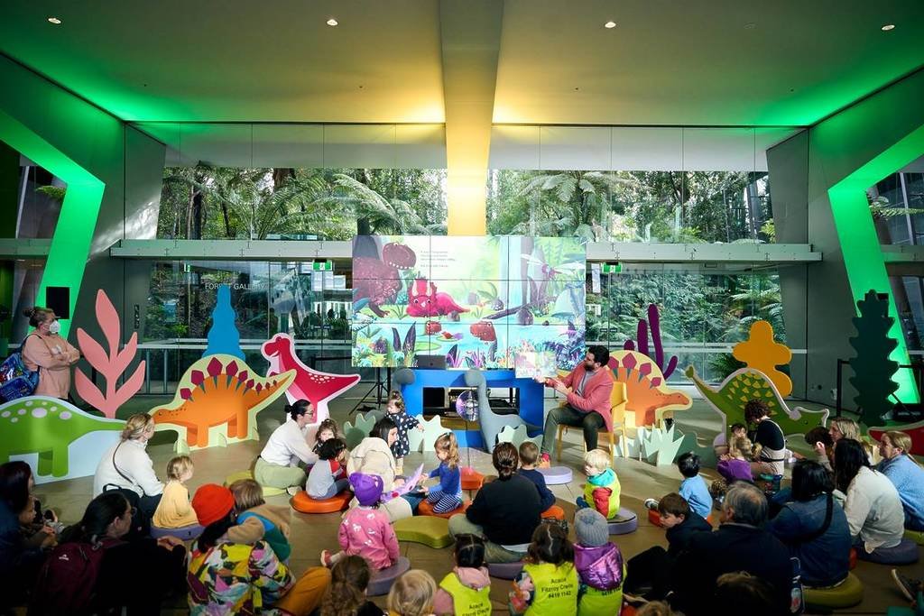 children and families playing with dinosaurs at Melbourne Museum