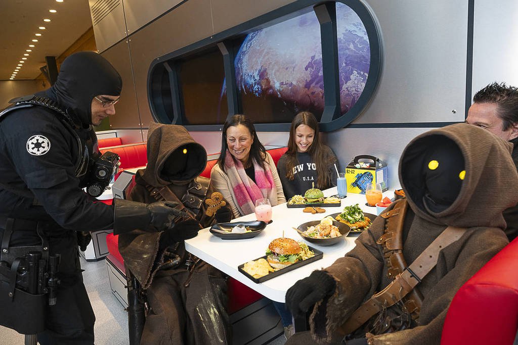 people dining at the Star Wars Galactic Cafe alongside Jawas