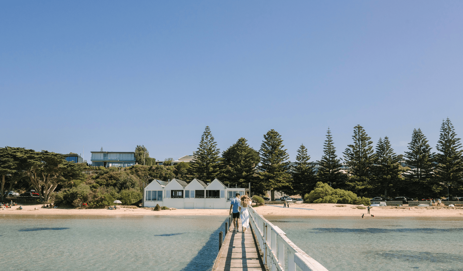 Couple walking along Sorrento Pier on a sunny day
